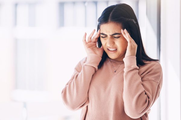 headache-stress-mockup-with-indian-woman-blurred-background-suffering-from-pain-anxiety-compliance-mental-health-burnout-frustrated-young-female-struggling-with-migraine